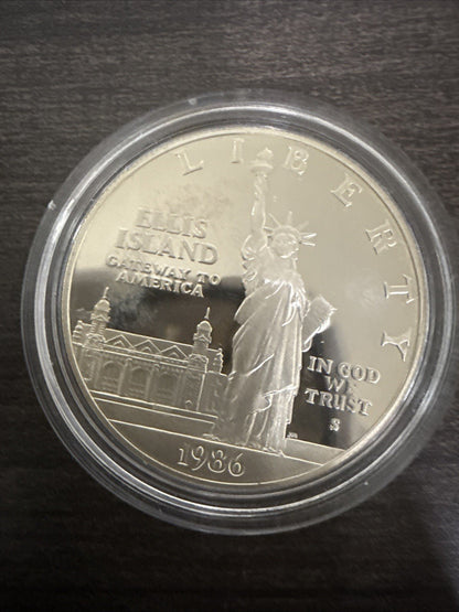 1986 - S Capsuled Ellis Island Gateway to America US Silver Dollar Liberty - toyscardscomics