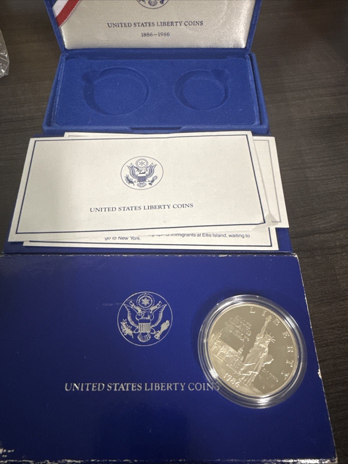 1986 - S Capsuled Ellis Island Gateway to America US Silver Dollar Liberty - toyscardscomics